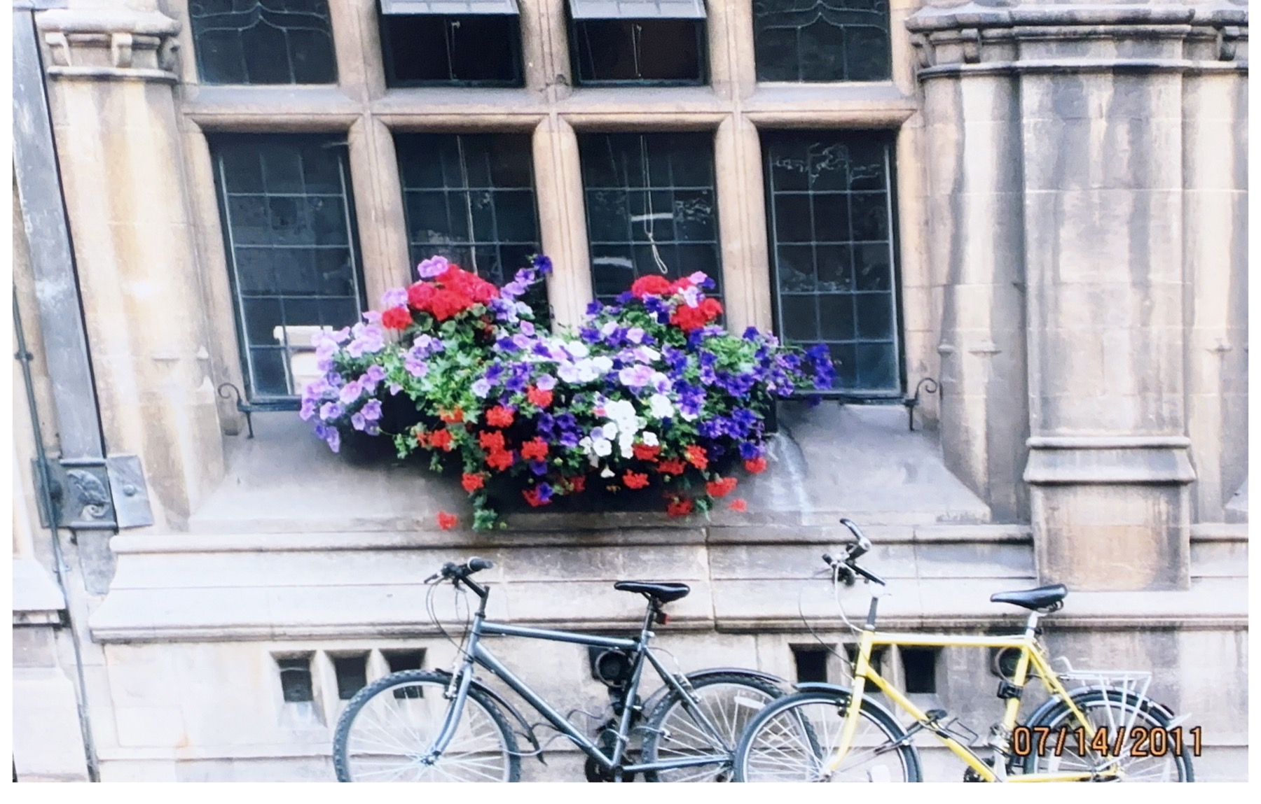 Bicycles and flowers outside an Oxford college building